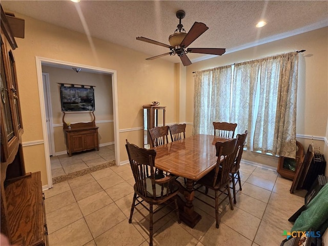 dining area with a textured ceiling, a ceiling fan, baseboards, recessed lighting, and light tile patterned floors