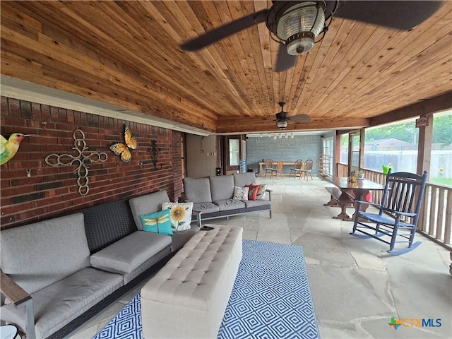 view of patio featuring an outdoor hangout area, fence, ceiling fan, and outdoor dining area