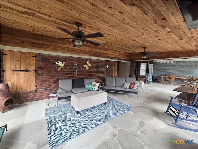 view of patio / terrace with ceiling fan and an outdoor living space