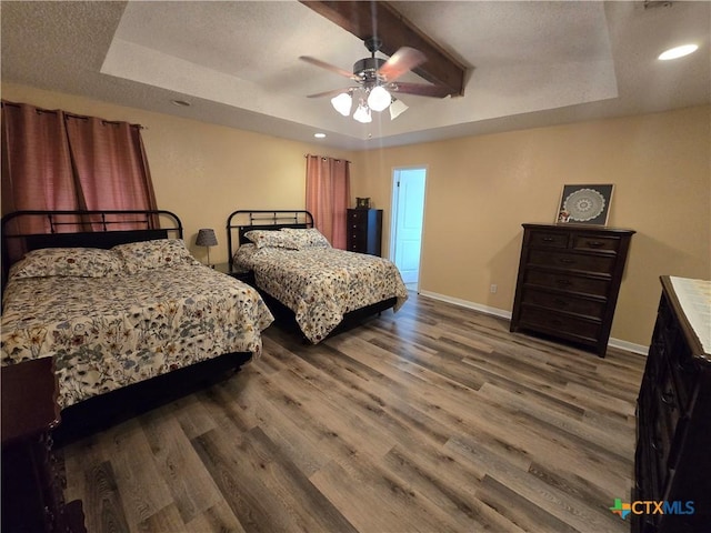 bedroom with ceiling fan, beam ceiling, wood finished floors, baseboards, and recessed lighting