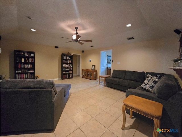 living room with ceiling fan, a textured ceiling, recessed lighting, light tile patterned floors, and visible vents
