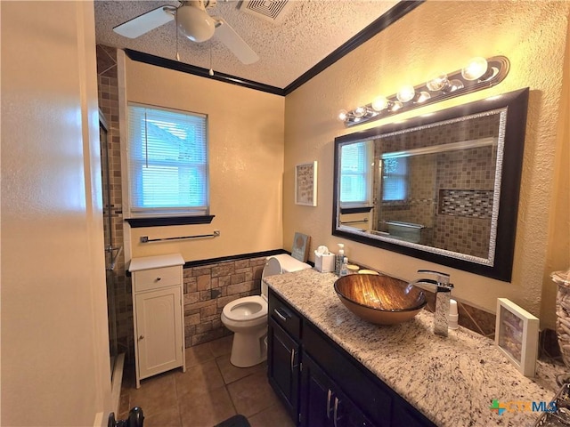 full bath featuring tile patterned flooring, visible vents, a textured ceiling, a ceiling fan, and a tile shower
