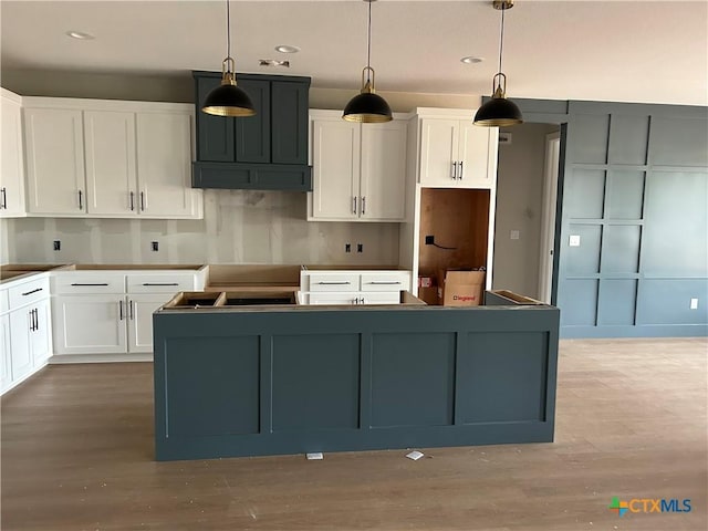 103 Still Meadow Dr, Kingsland, TX 78639 - kitchen featuring a kitchen island, light wood-type flooring, white cabinetry, recessed lighting, and decorative light fixtures
