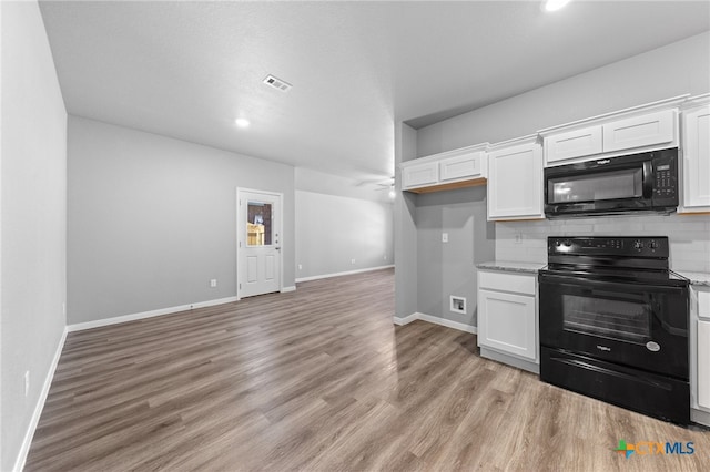 kitchen with visible vents, backsplash, black appliances, and white cabinetry