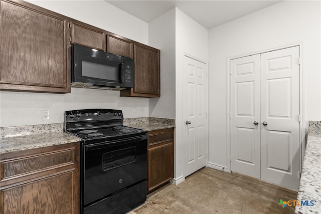 kitchen with black appliances, light stone countertops, and dark brown cabinets