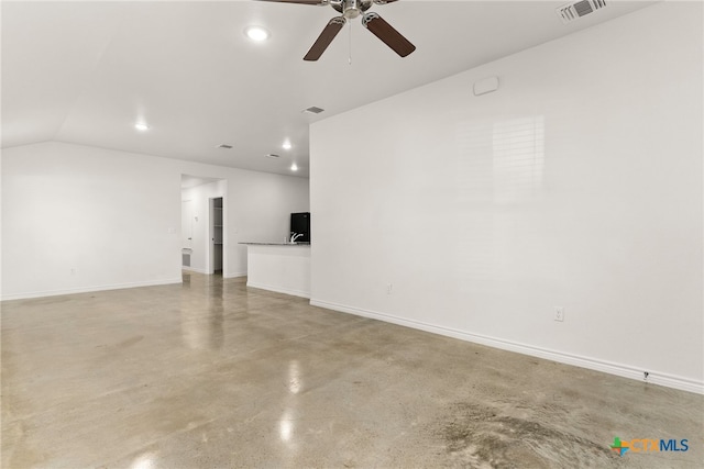 unfurnished living room with ceiling fan, concrete floors, and vaulted ceiling