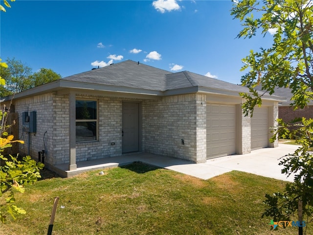 ranch-style house featuring a garage and a front yard