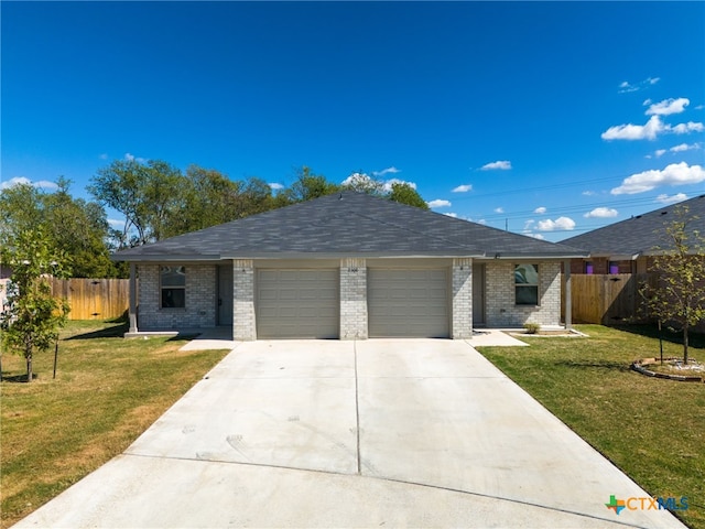 ranch-style home featuring a garage and a front yard