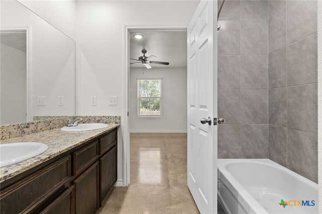 bathroom featuring concrete flooring, tiled shower / bath combo, vanity, and ceiling fan