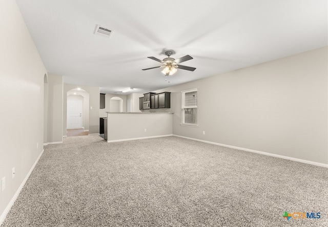 unfurnished living room featuring carpet flooring and ceiling fan