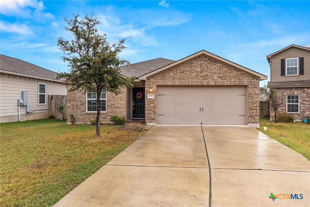 view of front of home with a front yard and a garage