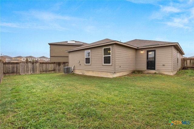 back of property with a lawn and cooling unit