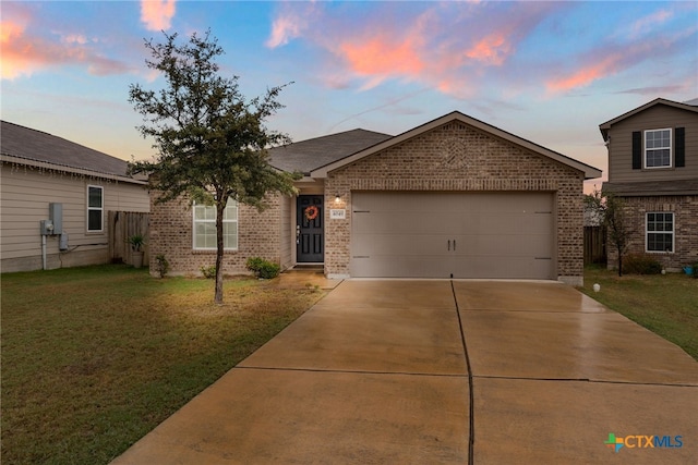 single story home featuring concrete driveway, brick siding, an attached garage, and a front yard