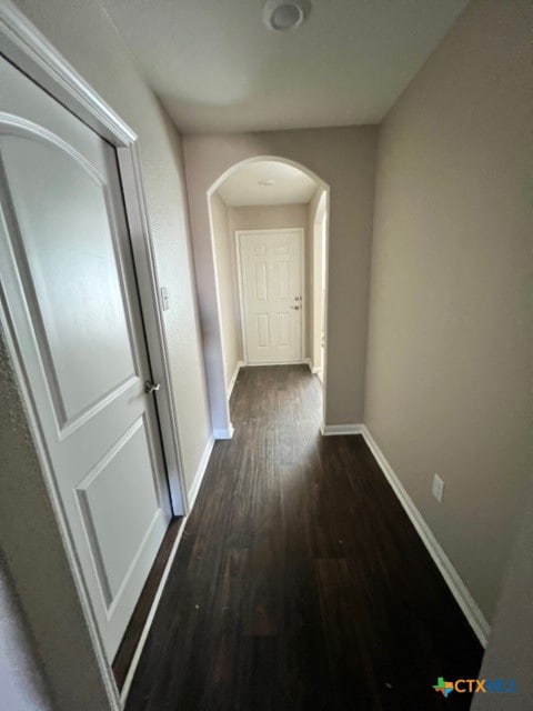 corridor featuring dark hardwood / wood-style flooring