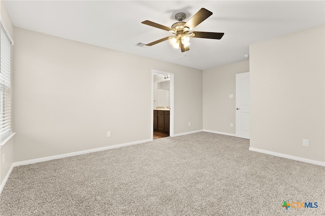 carpeted empty room featuring a ceiling fan, baseboards, and visible vents