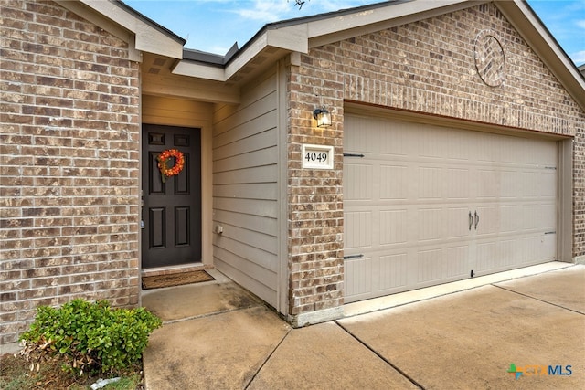 doorway to property featuring a garage