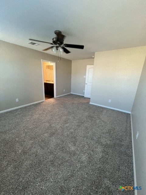 carpeted spare room featuring ceiling fan