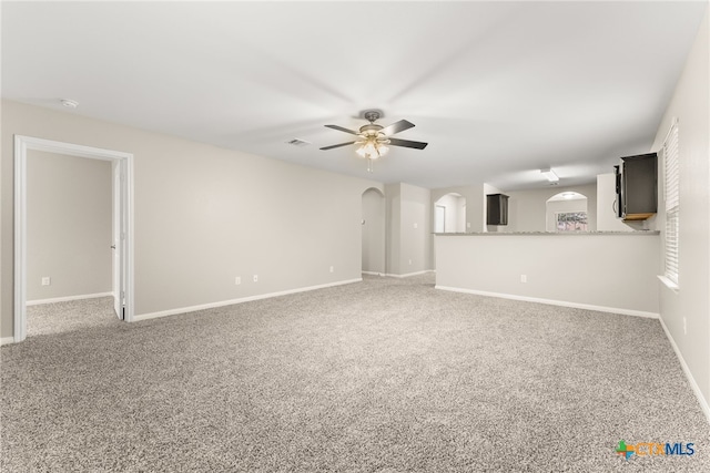 unfurnished living room featuring carpet flooring and ceiling fan