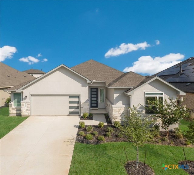 view of front facade featuring a garage and a front yard