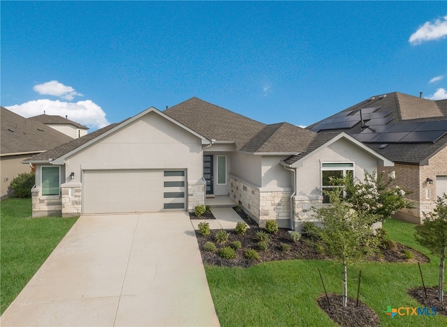 view of front of house featuring a garage and a front yard