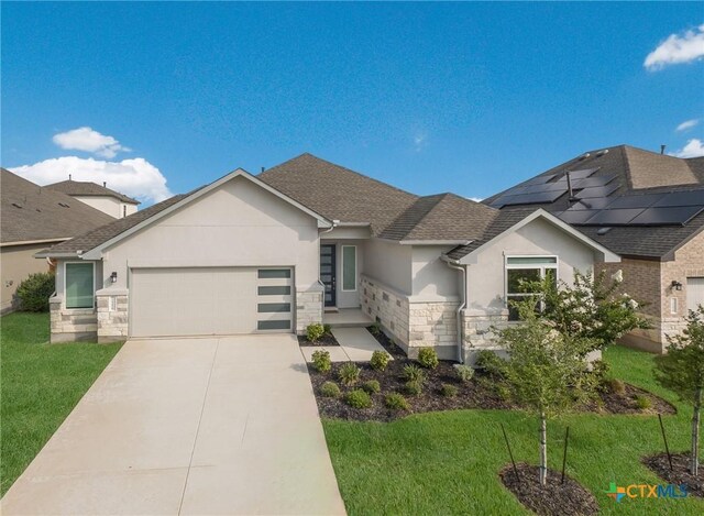 2258 Hoja Ave, New Braunfels, TX 78132 - view of front of property featuring stone siding, stucco siding, a garage, and a front yard