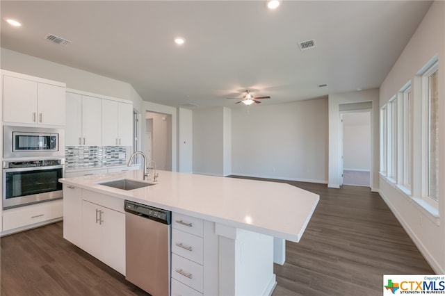 kitchen with white cabinetry, appliances with stainless steel finishes, a center island with sink, and sink