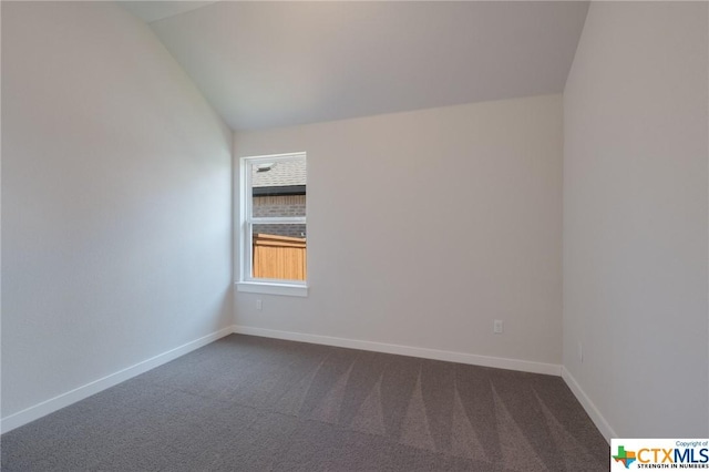 2258 Hoja Ave, New Braunfels, TX 78132 - spare room with dark colored carpet, baseboards, and vaulted ceiling