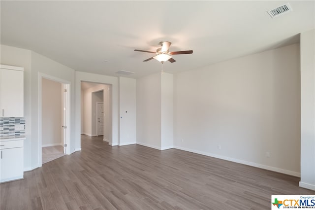 unfurnished living room with ceiling fan and light wood-type flooring