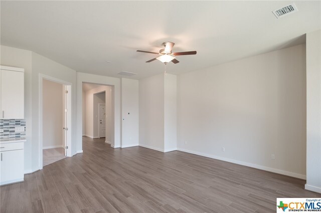 unfurnished living room with ceiling fan and light wood-type flooring