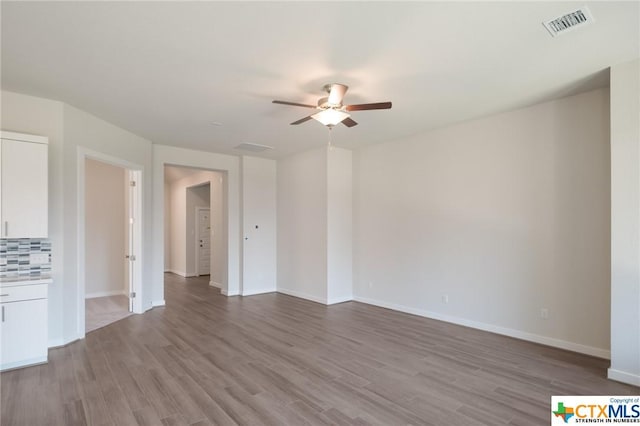 2258 Hoja Ave, New Braunfels, TX 78132 - spare room with ceiling fan, wood finished floors, and baseboards