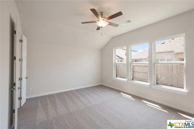 additional living space with vaulted ceiling, carpet flooring, and ceiling fan