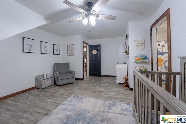 living area featuring ceiling fan and light wood-type flooring