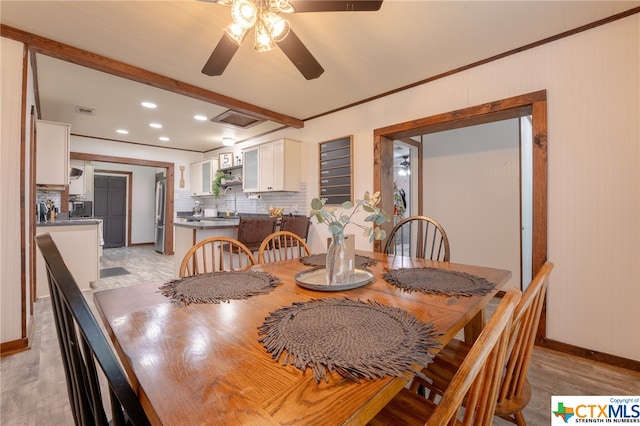 dining area featuring ceiling fan, light wood-type flooring, and ornamental molding