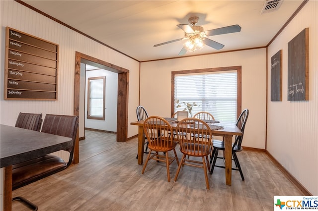 dining area featuring hardwood / wood-style floors, ceiling fan, and ornamental molding