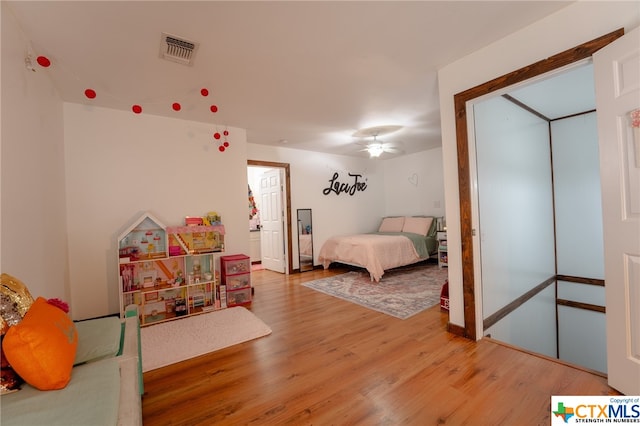 bedroom featuring hardwood / wood-style flooring and ceiling fan