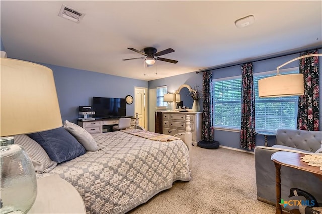 bedroom with carpet floors, ceiling fan, visible vents, and baseboards