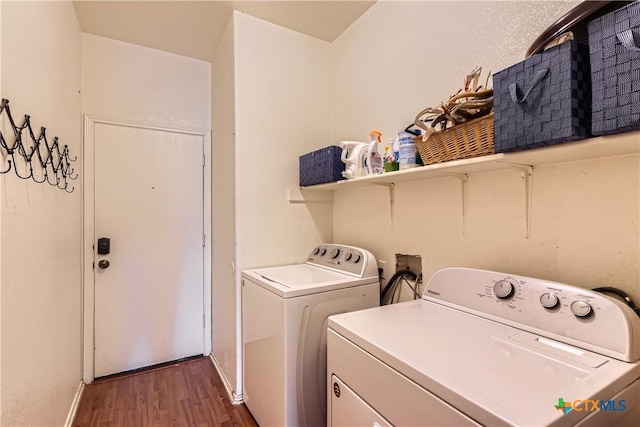 clothes washing area with laundry area, baseboards, independent washer and dryer, and wood finished floors