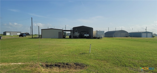 view of yard featuring an outbuilding and a carport