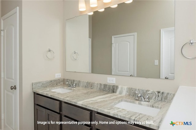 full bathroom with double vanity and a sink