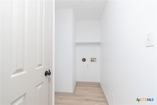 washroom featuring light wood-type flooring, laundry area, baseboards, and washer hookup