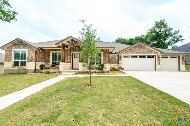 view of front facade with covered porch, brick siding, a garage, driveway, and a front lawn