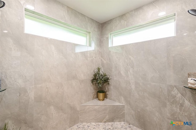 full bath with a tile shower
