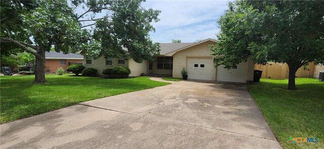 4009 Mockingbird Ln, Temple, TX 76502 - view of front of home with concrete driveway, a garage, and brick siding