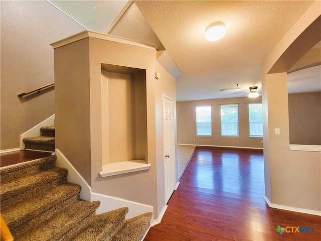 9200 Ashlyn Dr, Killeen, TX 76542 - corridor with wood finished floors, stairway, and a textured ceiling
