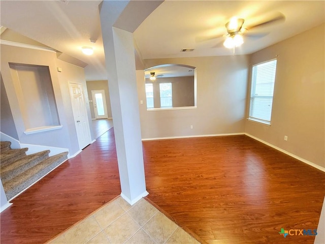 9200 Ashlyn Dr, Killeen, TX 76542 - unfurnished room featuring ceiling fan, wood finished floors, arched walkways, and stairs