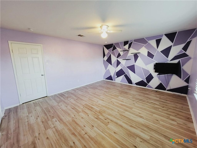 9200 Ashlyn Dr, Killeen, TX 76542 - unfurnished room with a ceiling fan, an accent wall, and wood finished floors