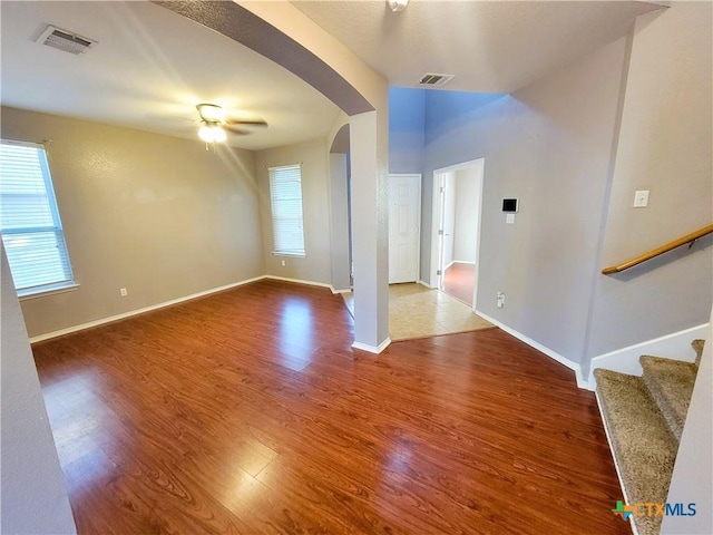 9200 Ashlyn Dr, Killeen, TX 76542 - spare room featuring arched walkways, wood finished floors, ceiling fan, and stairs