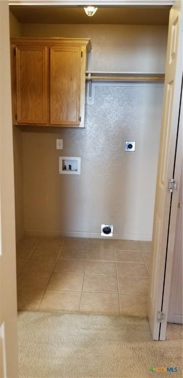 1207 Nicholas Cir, Killeen, TX 76542 - laundry room featuring hookup for an electric dryer, washer hookup, light tile patterned floors, and baseboards