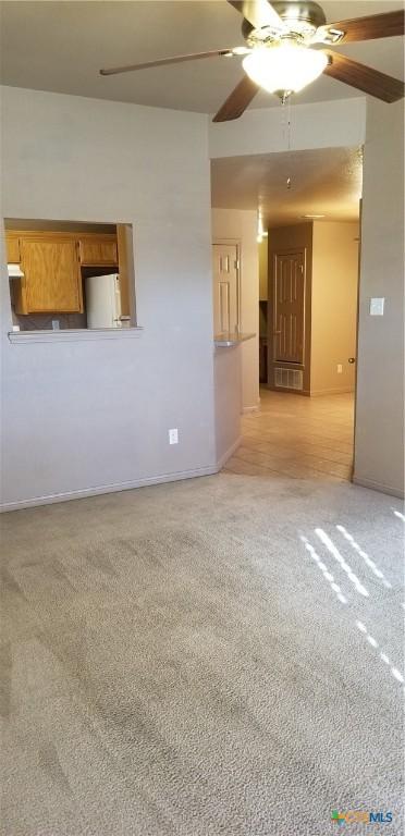 1207 Nicholas Cir, Killeen, TX 76542 - empty room with a ceiling fan, light colored carpet, and baseboards