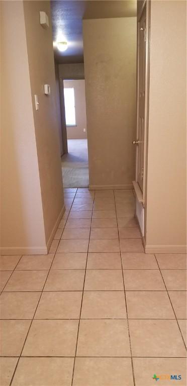 1207 Nicholas Cir, Killeen, TX 76542 - hall with light tile patterned floors and baseboards